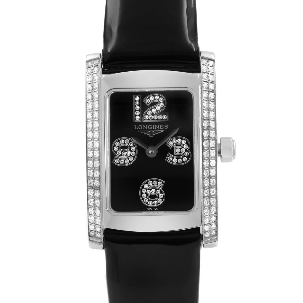 An image of a wristwatch viewed from the front in a close-up shot, focusing on the watch face. The rectangular face features large, embellished numerals at the 12, 3, 6, and 9 o'clock positions. The watch has a sleek black band and a silver-toned casing with decorative accents on the sides. The display model is shown in pristine condition.