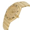 An image of a pre-owned wristwatch taken from a side profile view, highlighting the crown on the right side. The watch features a gold-tone case and bracelet, with Roman numeral hour markers on the bezel. The angle showcases the watch at a slight tilt, emphasizing its sleek design and metallic finish, captured from a close distance.