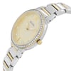 An image of a Bulova women's wristwatch, displayed as a model at a close-up angle focusing on the upper left quadrant of the watch. The watch has a gold-toned dial, luminous hands, and is adorned with clear diamonds around the bezel. The two-tone bracelet combines silver and gold elements, and the Bulova logo is visible at the center of the dial. The crown is positioned on the right side of the watch case.