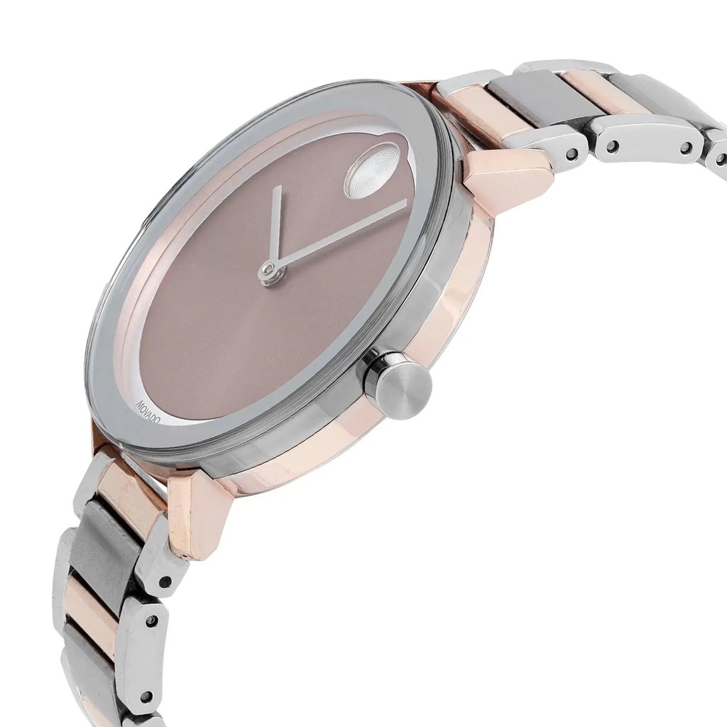 An image of a pre-owned wristwatch taken from a side profile view, showcasing the crown prominently. The watch features a sleek design with a smooth, round face and a metal bracelet. The angle highlights the watch's thickness and the detailing on the bracelet links.