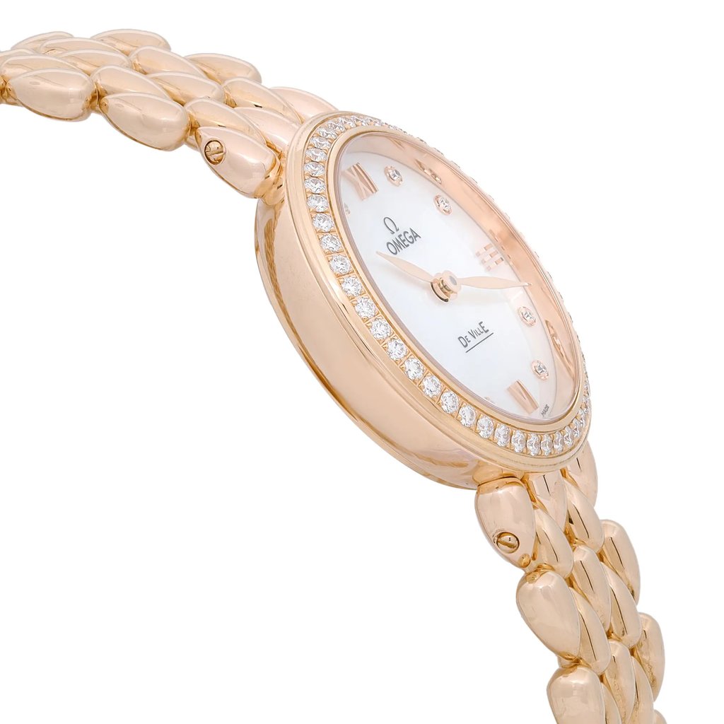 An image of a wristwatch viewed from a side profile, opposite the crown. The watch features a gold-tone bracelet and a round case adorned with a ring of sparkling stones around the bezel. The face is elegantly designed, showcasing a clean and sophisticated look. The angle captures the watch’s thickness and the smooth curvature of the bracelet links, emphasizing its luxurious appearance.