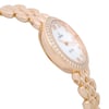 An image of a wristwatch viewed from a side profile, opposite the crown. The watch features a gold-tone bracelet and a round case adorned with a ring of sparkling stones around the bezel. The face is elegantly designed, showcasing a clean and sophisticated look. The angle captures the watch’s thickness and the smooth curvature of the bracelet links, emphasizing its luxurious appearance.