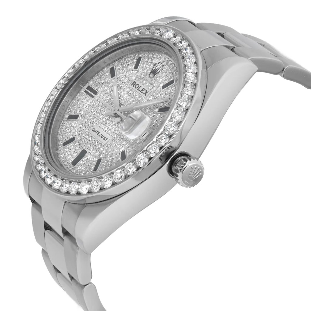 An image of a pre-owned wristwatch viewed from the side profile, showcasing the crown prominently. The watch features a silver-tone bracelet and a sparkling bezel. The watch face is textured with metallic accents and hour markers. The angle highlights the intricate details and craftsmanship of the timepiece, with the focus on the side and crown, captured from a close distance.