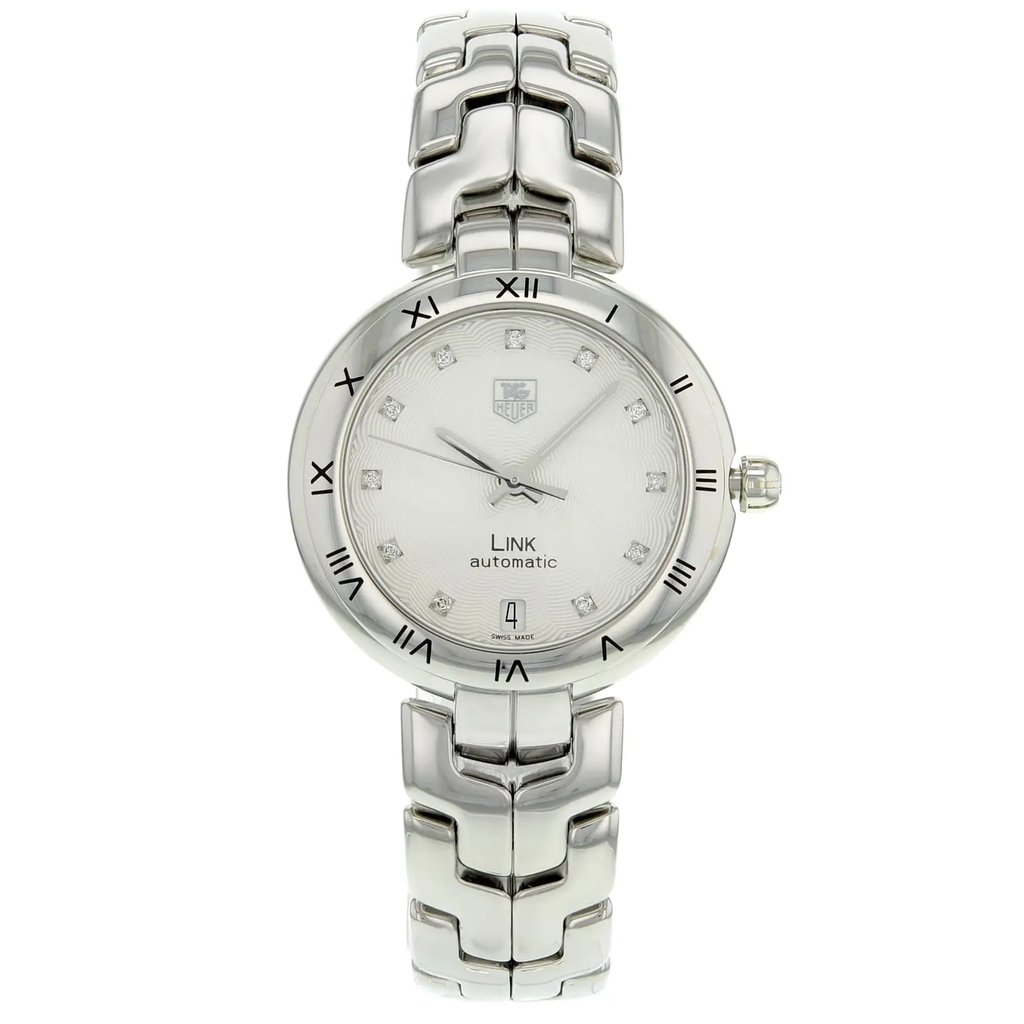 An image of a Wristwatch by TAG Heuer. This Pre Owned item is designed for Women, featuring a Dress/Formal style. It has a Mechanical (Automatic) movement and an Analog display with a Silver dial color. The indices include 12-Hour Dial,Diamond Markers. The band is made of Stainless Steel and the case is made of Stainless Steel. The watch has a Round shape with a case size of 34 mm and a case thickness of 10 mm.