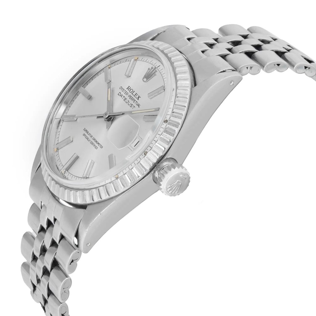 An image of a pre-owned wristwatch shown from a side profile view, highlighting the crown. The watch features a metallic bracelet with a textured bezel and a detailed crown. The angle provides a clear view of the watch's face and side, capturing the intricate design elements. The watch is positioned close-up, emphasizing its polished finish and craftsmanship.