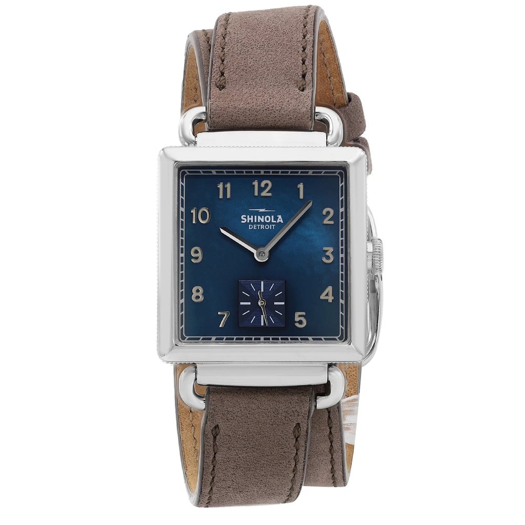 An image of a wristwatch taken from a front full frontal view. The watch features a rectangular face with a blue dial and silver numerals. The case is metallic, and the watch is equipped with a brown leather strap. The watch appears to be a display model, captured from a close distance, emphasizing its details and craftsmanship.