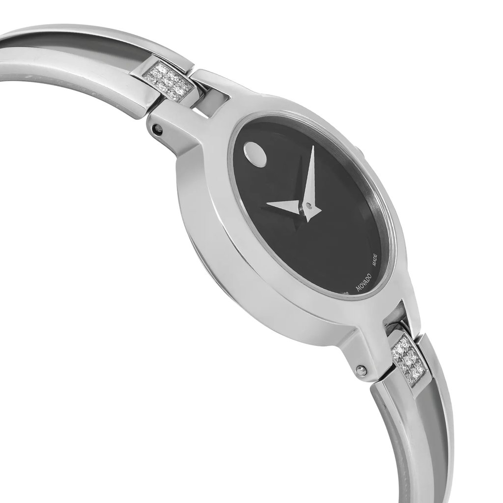 An image of a pre-owned wristwatch captured from a side profile view, opposite the crown. The watch features a sleek, metallic band with embedded stones, and a dark dial with minimalist markers. The angle showcases the curvature of the band and the design details of the watch face, taken at a close distance.