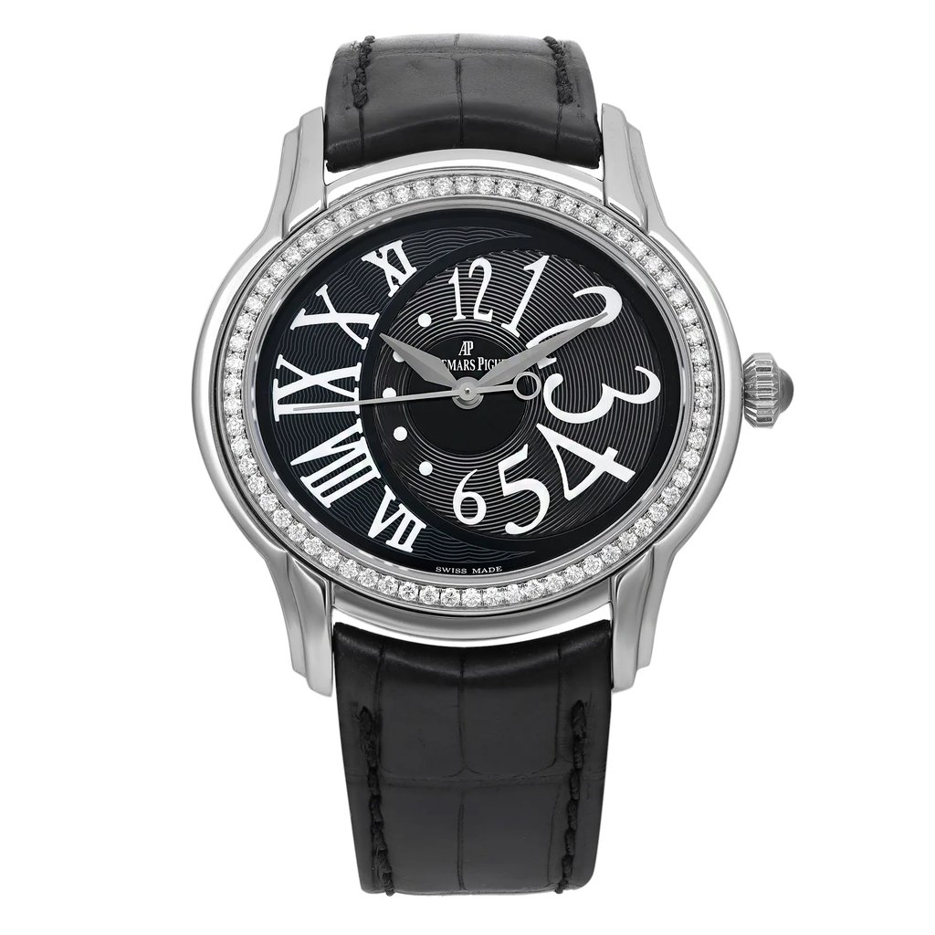 An image of a pre-owned wristwatch viewed from a front full frontal angle. The watch features a black leather strap and a round face with bold, white numerals. The bezel is adorned with small, sparkling stones, and the dial has a subtle textured pattern. The watch is positioned centrally, capturing all its details clearly.