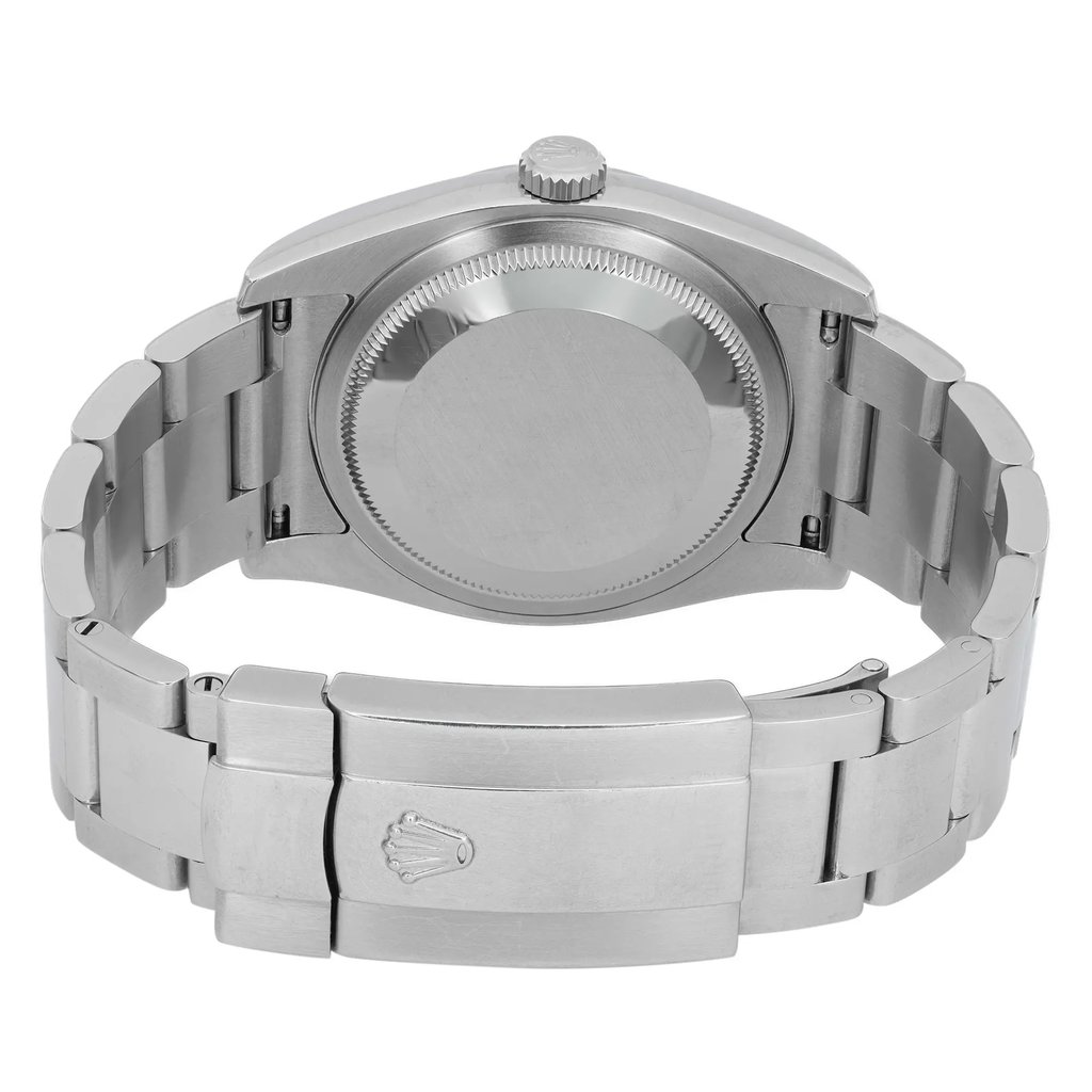 An image of a pre-owned wristwatch showing the back view. The angle highlights the closed clasp and the smooth, polished surface of the watch's back, revealing its metallic finish. The photograph is taken at a close distance, emphasizing the details of the bracelet links and the clasp mechanism.