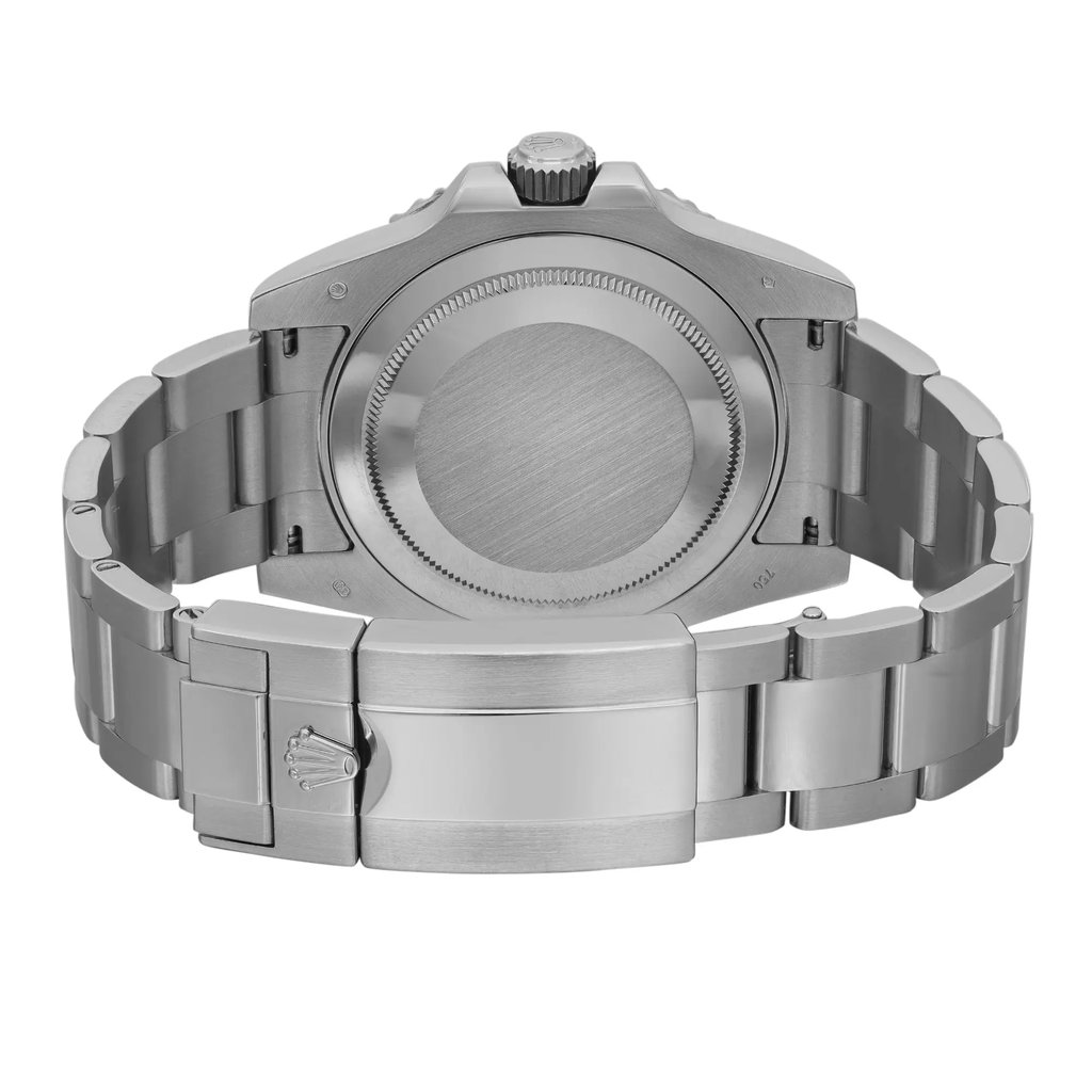 An image of a pre-owned Rolex men's wristwatch in a back view, showcasing a screwback case and a closed fold-over clasp with flip lock safety. The watch, positioned centrally and displayed at a direct angle, has a round white gold case and matching band. Light scratches may be visible on the surfaces, indicating its pre-owned condition. The photo is taken from a medium distance, providing a clear view of the watch's back and clasp details.