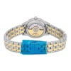 An image of a new wristwatch viewed from the back, highlighting the close clasp. The watch features a silver and gold-toned metal bracelet. The focus is on the transparent case back, showcasing the mechanical movement inside, with protective blue plastic covering the clasp area. The angle is straight-on, capturing the watch at a close distance to emphasize the details.