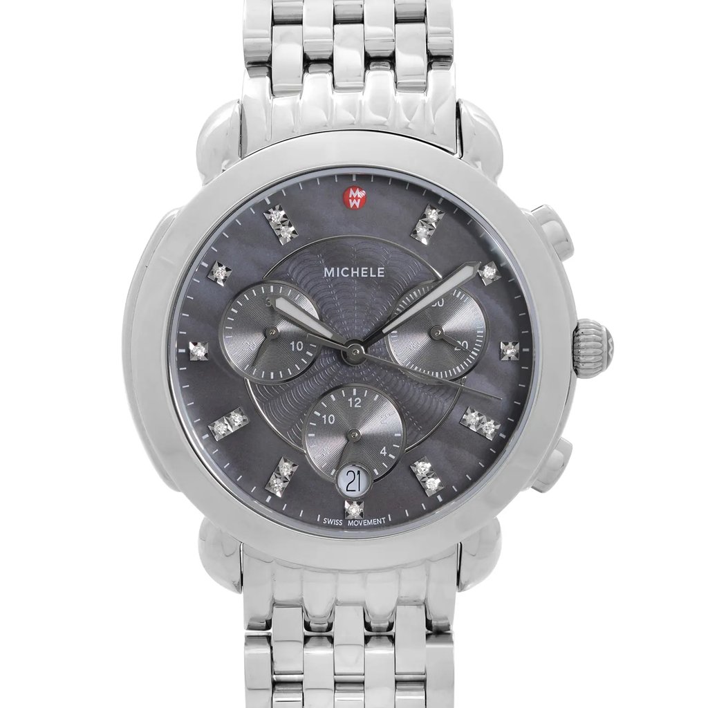 An image of a wristwatch captured in a front close-up shot, showcasing the watch face. The watch features a polished metallic bracelet and a dark dial adorned with small, sparkling markers and three subdials. The date display is positioned at the bottom. This is a display model, emphasizing its pristine condition.