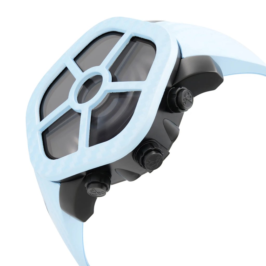 An image of a luxury men's wristwatch by JACOB & Co., shown in an unworn condition from a side profile angle with all crowns visible. The watch features a unique pentagon shape with a black dial and a blue bezel. It is constructed from stainless steel with a rubber band. The photo is taken at a close distance, emphasizing the watch's side and the texture of the rubber band.