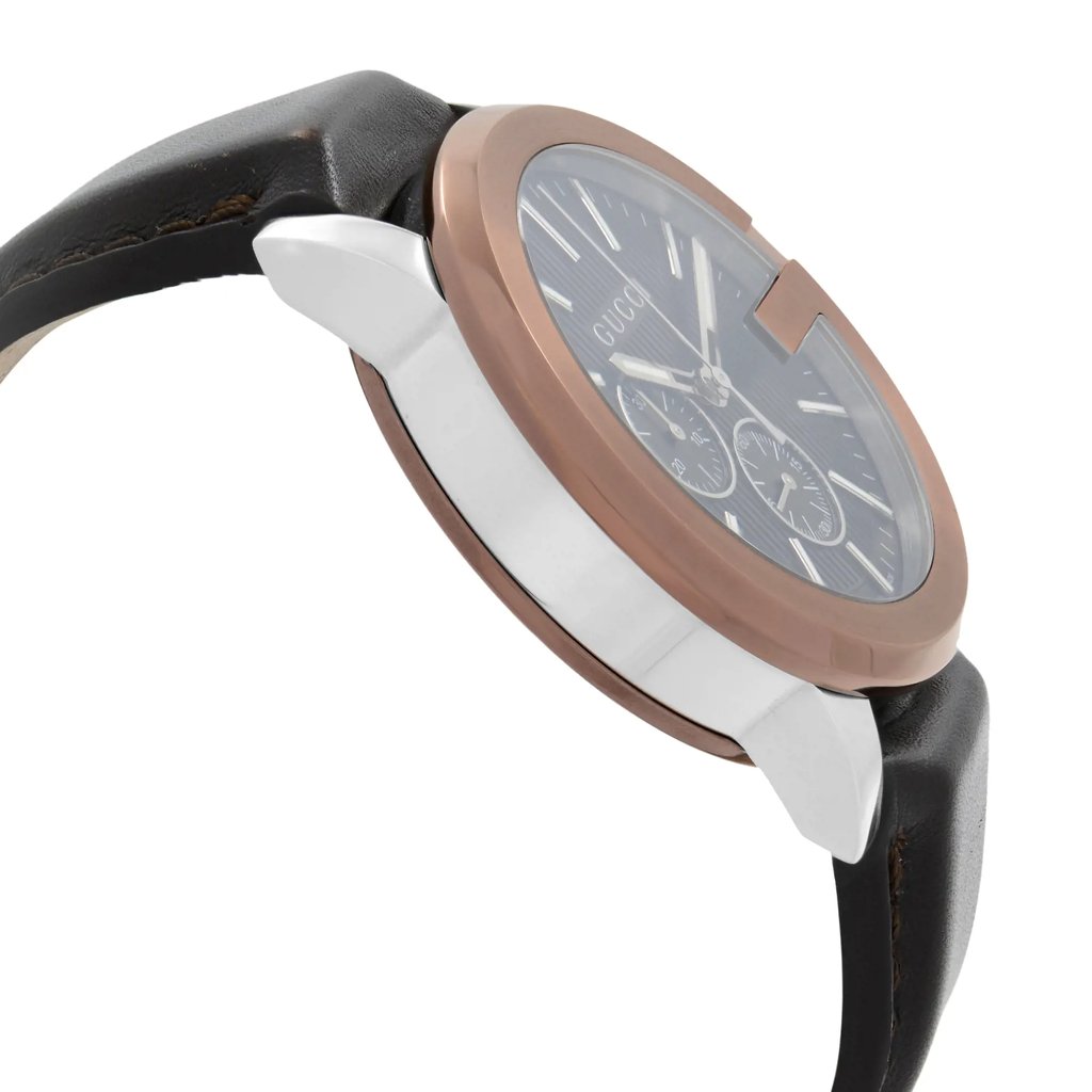 An image of a pre-owned Gucci men's wristwatch in a dress/formal style, shown from a side profile view opposite of the crown. The watch features a round stainless steel case with a bronze bezel and a black teaked dial. It includes a chronograph, luminous hands, and a small seconds subdial. The watch is fitted with a black leather band and is positioned at a medium distance, with the side angle highlighting the watch's thickness and the curvature of the case.
