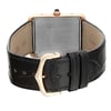 An image of a pre-owned Cartier women's wristwatch with a rectangle shape, viewed from the back showing the closed clasp. The watch has a rose gold screwback case positioned at the center and a black leather band with a buckle closure. The caseback is engraved with the brand and watch specifics, and the band exhibits minor signs of wear. The rose gold buckle and the image is taken from a close, slightly angled distance, emphasizing the details of the caseback and clasp.