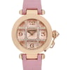An image of a pre-owned Cartier women's wristwatch, featuring a round rose gold case with a prominent date indicator. The watch has a pink leather strap and is viewed from a front angle, showcasing the intricate dial design with diamond accents. The photo captures the watch at a close distance, emphasizing its elegant details and craftsmanship.
