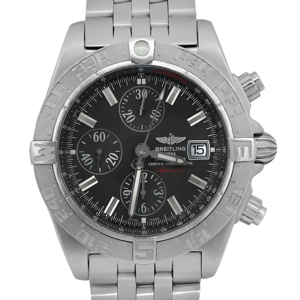 An image of a pre-owned Breitling men's wristwatch in a pilot/aviator style, featuring a front close-up shot of the watch face. The round dial is black with baton indexes and a 12-hour display, complemented by a gray bezel. The stainless steel band and case are visible, with the watch positioned to show the watch face at a straight-on angle, occupying most of the frame for a detailed view. The dial has minor patina on the hours markers and shows light signs of scratches on the bezel.