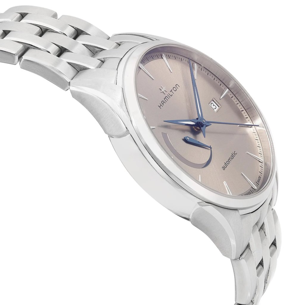 An image of a pre-owned wristwatch captured from a side profile view, opposite the crown. The watch features a metallic band and a round dial with a subtle sheen. The angle highlights the watch's sleek design and detailing on the face, and the shot is taken from a close distance to emphasize texture and craftsmanship.