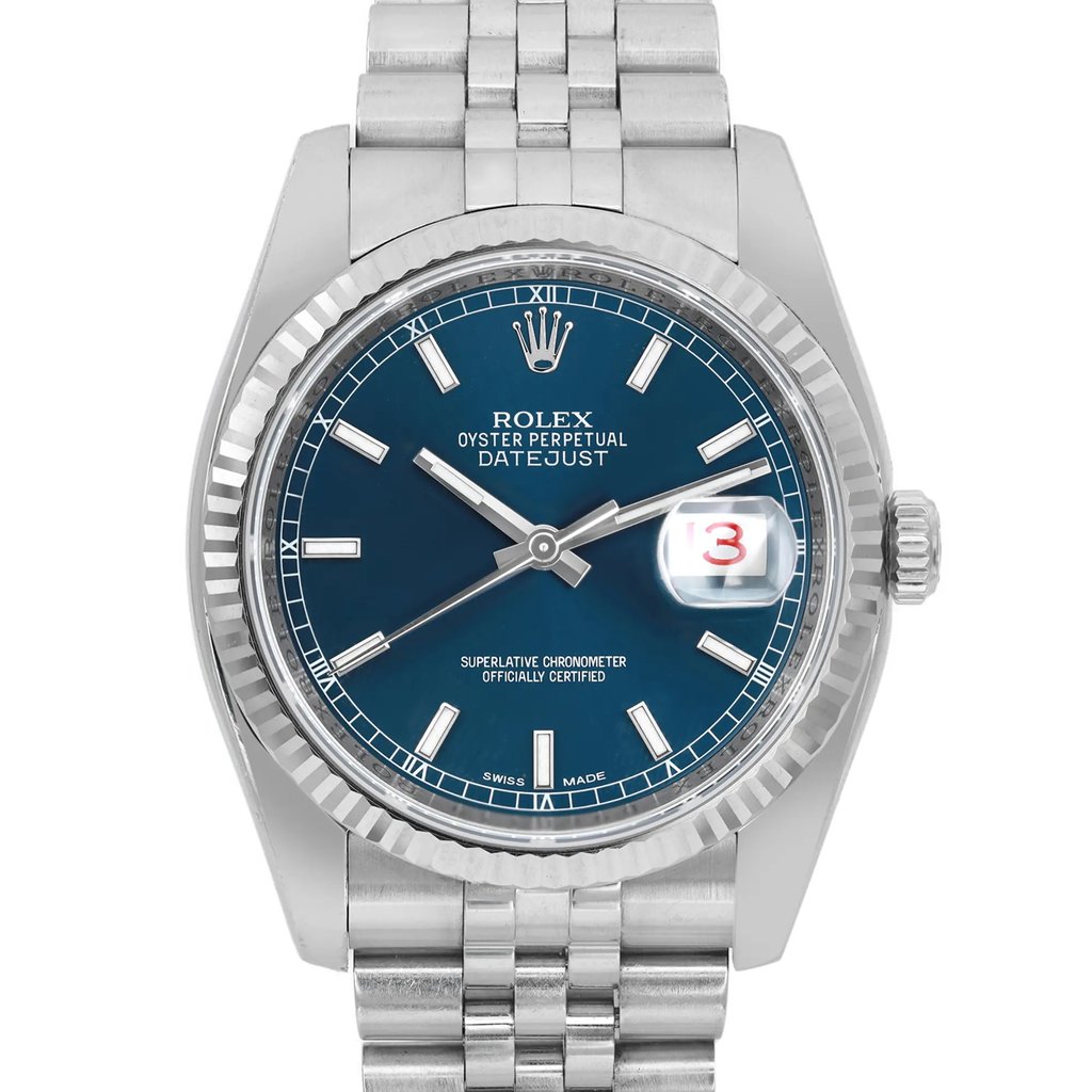 An image of a pre-owned wristwatch captured from a front close-up angle. The watch features a blue dial with silver hour markers and hands. The brand name and model details are visible on the watch face, along with a date display magnified at the 3 o'clock position. The bezel is fluted, and the metal bracelet is partially visible at the top and bottom.