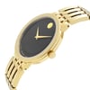 An image of a wristwatch taken from a side profile view, showcasing the crown prominently. The watch features a gold band and a black face with minimalistic gold hands and a circular gold marker. The angle highlights the watch's sleek design, accentuating its new condition, despite being described as "new with defects." The photograph is taken from a close distance, capturing fine details of the watch's craftsmanship.