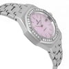 An image of a pre-owned women's Audemars Piguet wristwatch. The watch is positioned at a slight angle from above, showcasing its elegant design. The face is a soft pink with a textured pattern, surrounded by a bezel adorned with sparkling diamonds. The bracelet is made of stainless steel with a polished finish. The shot is taken from a close distance, highlighting the intricate details of the watch.