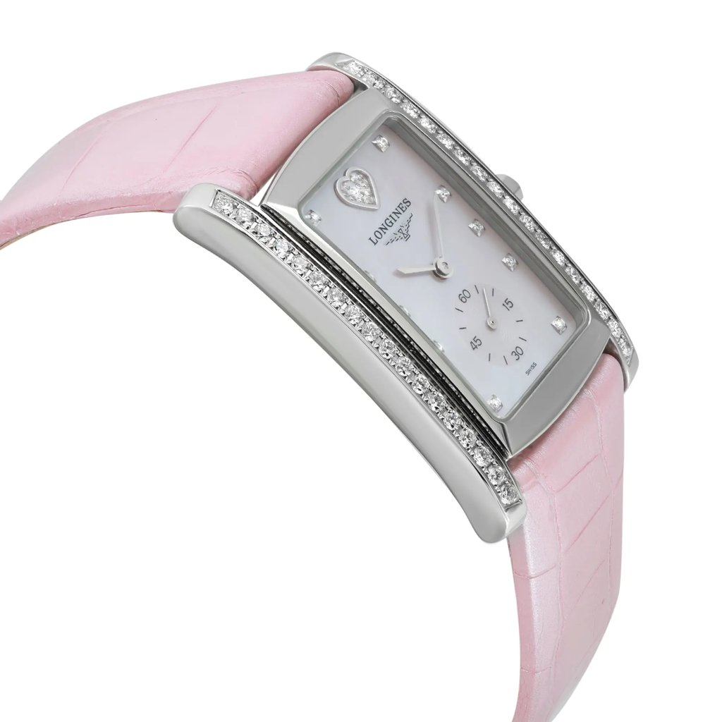An image of a wristwatch in an unworn condition, shown from a side profile view opposite the crown. The watch features a rectangular face with a silver-tone bezel adorned with small gemstones. The dial is white with diamond hour markers and a subtle subdial at the six o'clock position. The watch is set in a polished metal case with a light pink leather strap. The angle highlights the elegant curve of the strap and the watch's sleek design.