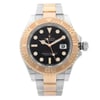 An image of a pre-owned wristwatch shown from a front full-frontal view. The watch features a metallic band with a two-tone design, combining silver and rose gold elements. The bezel is marked with numbers and is rose gold in color, while the dial is black with distinct hour markers and a date window. The watch hands and markers are also highlighted in rose gold. The crown is positioned on the right side. The image is captured at a close distance, focusing on the watch's face and details.
