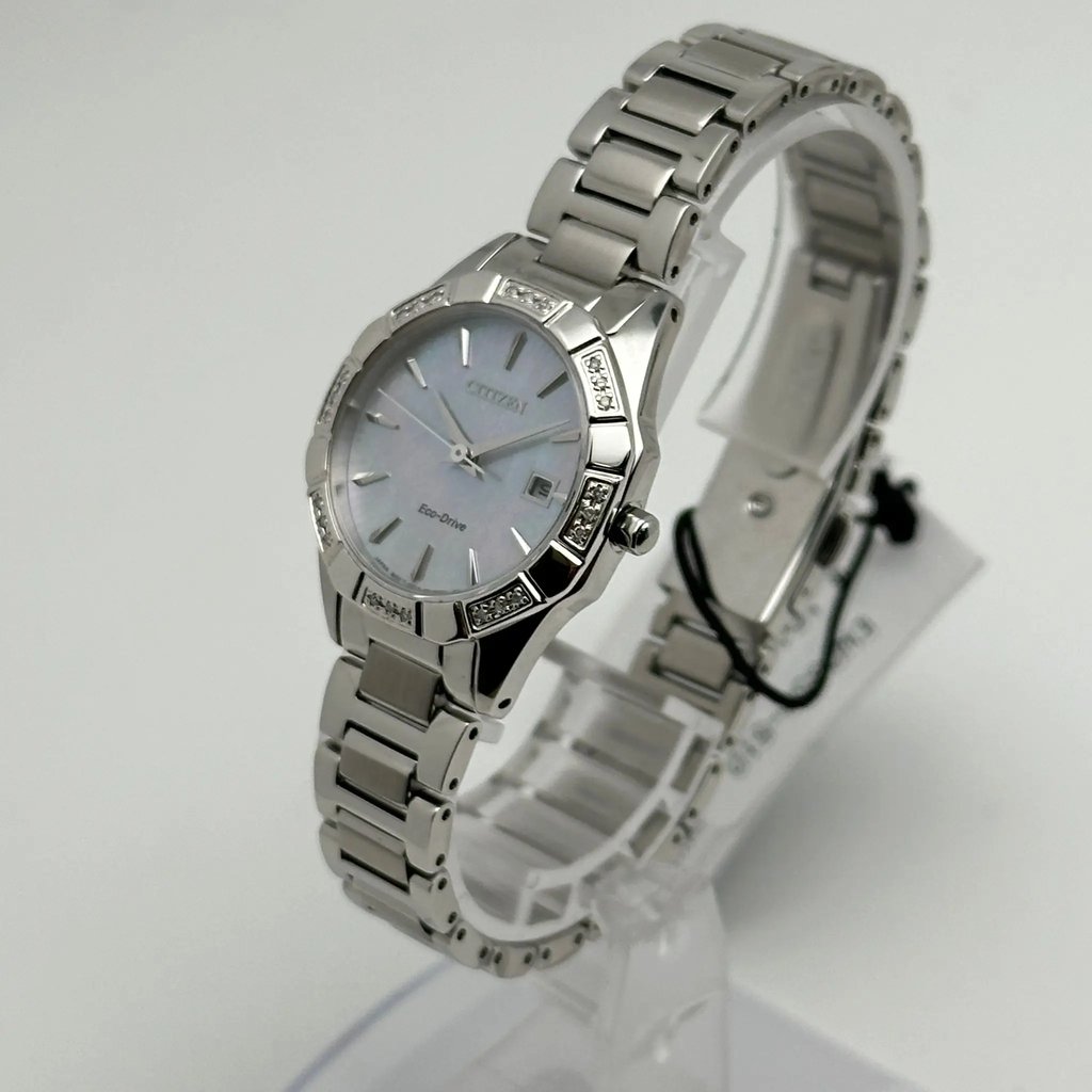 An image of a Wristwatch by Citizen. This Display Model item is designed for Women, featuring a Dress/Formal style. It has a Quartz movement and an Analog display with a Silver dial color. The indices include 12-Hour Dial,No Hour Marks. The band is made of Stainless Steel and the case is made of Stainless Steel. The watch has a Round shape with a case size of 29 mm and a case thickness of 8 mm.