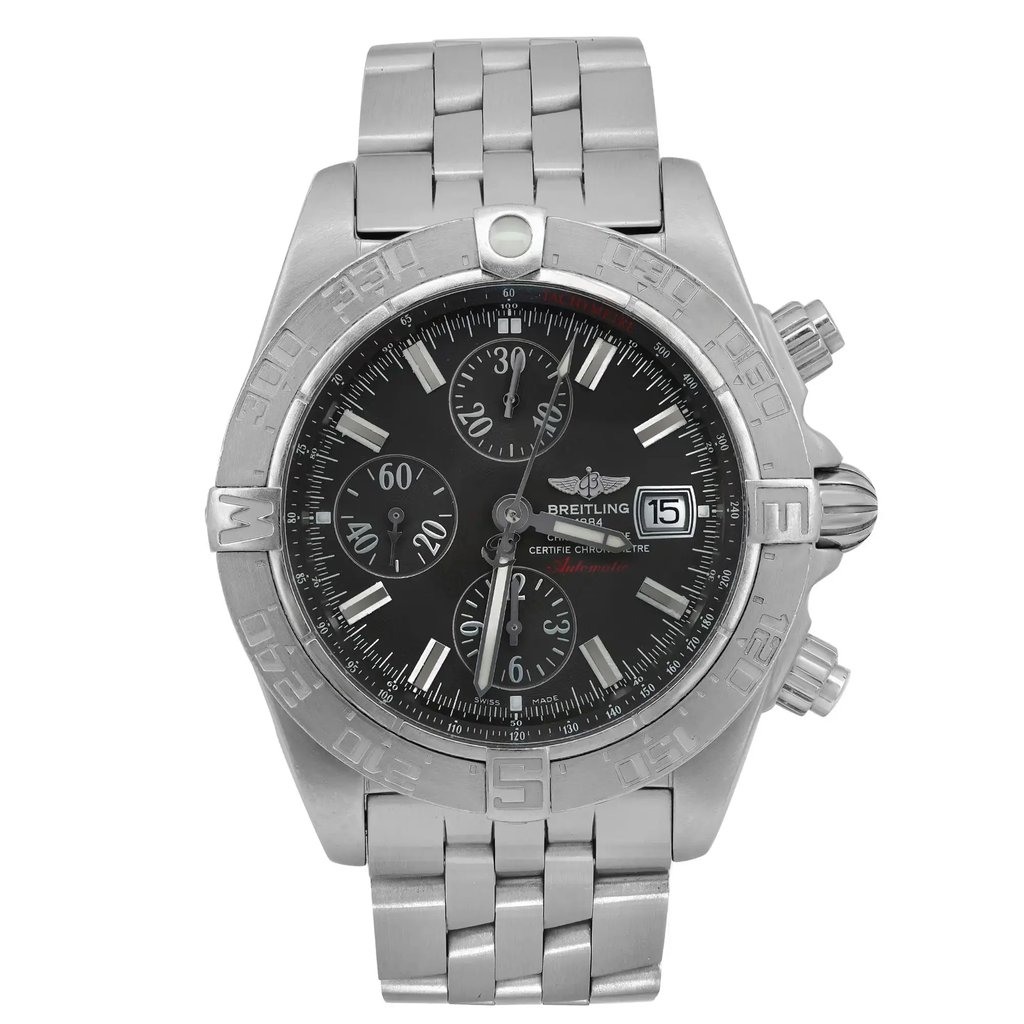An image of a pre-owned Breitling men's wristwatch, shown in a frontal view with the watch facing directly towards the camera. The watch is centered in the frame, allowing a clear view of the dial, bezel, and bracelet. The dial is black with minor patina on the hour markers and features three sub-dials, a date window at the 3 o'clock position, and the Breitling logo. The stainless steel bezel has engraved numbers and markers. The watch has visible light scratches indicative of previous wear. The watch is positioned at a neutral angle with no tilt, providing a full and unobstructed view of its features.