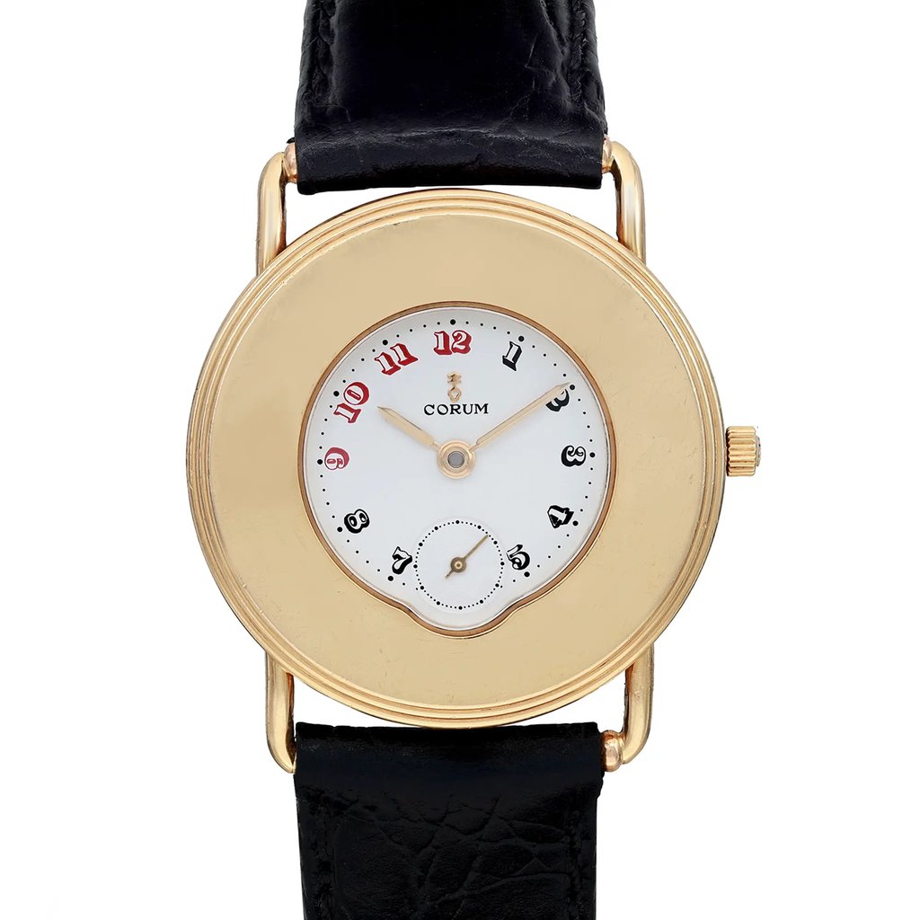 An image of a pre-owned wristwatch, captured in a front close-up shot focusing on the watch face. The watch features a gold round casing, a white dial with red and black numerals, and a small sub-dial. The black leather strap is visible at the top and bottom edges of the image.