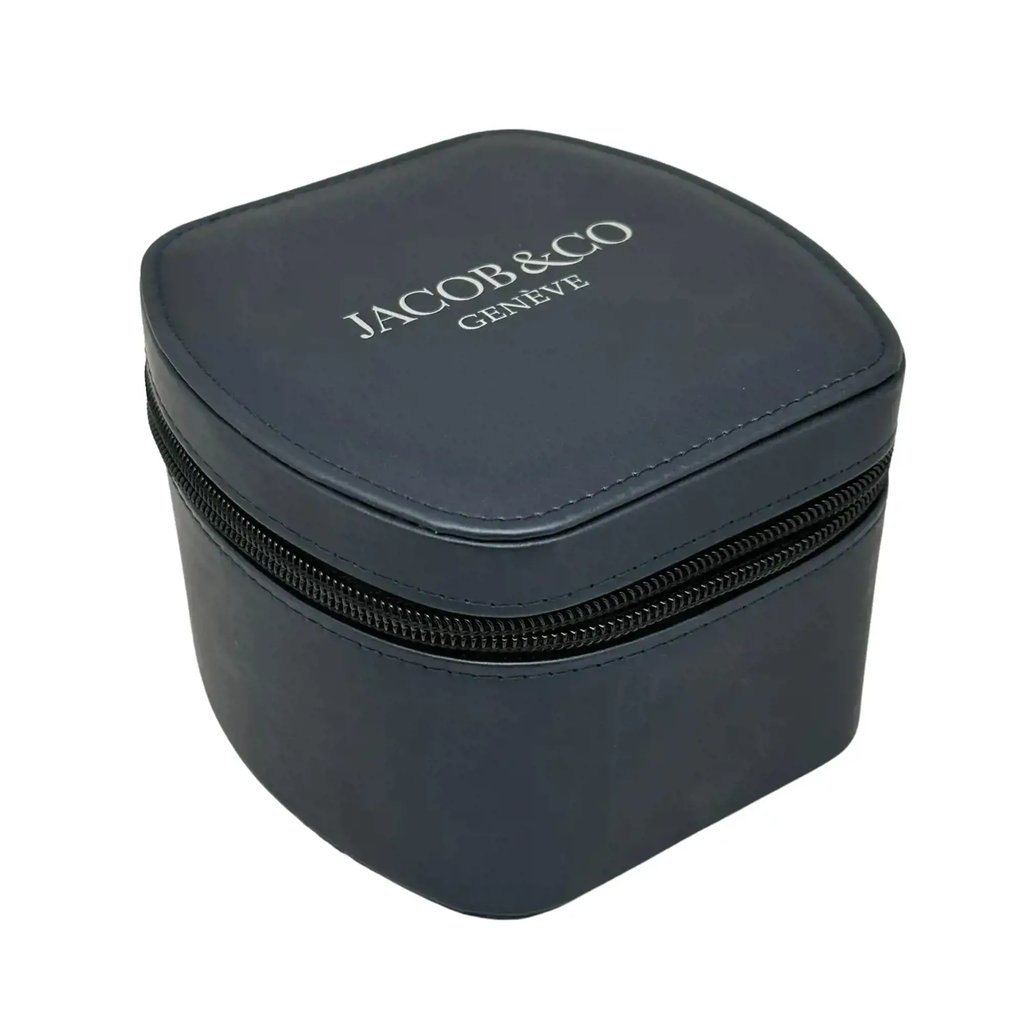 An image of a dark leather wristwatch box with a zippered closure, positioned at a slight angle. The box is shown from a close distance, highlighting the brand name "Jacob & Co Geneve" in white on the top surface. The watch itself is not present in the image.