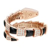 An image of a pre-owned wristwatch viewed from the back, showcasing its closed clasp. The watch features a coiled bracelet design with alternating black segments and diamond-studded sections. The angle captures the intricate details of the clasp and the luxurious materials from a close distance, emphasizing its craftsmanship.