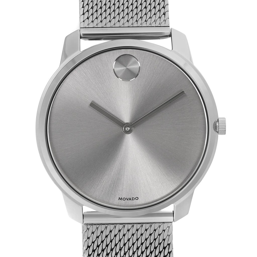 An image of a wristwatch showing a close-up, frontal view of the watch face. The watch features a minimalist design with a silver dial and two sleek black hands. The case is metallic with a matching textured metal strap visible at the top and bottom. The watch is a display model in pristine condition.