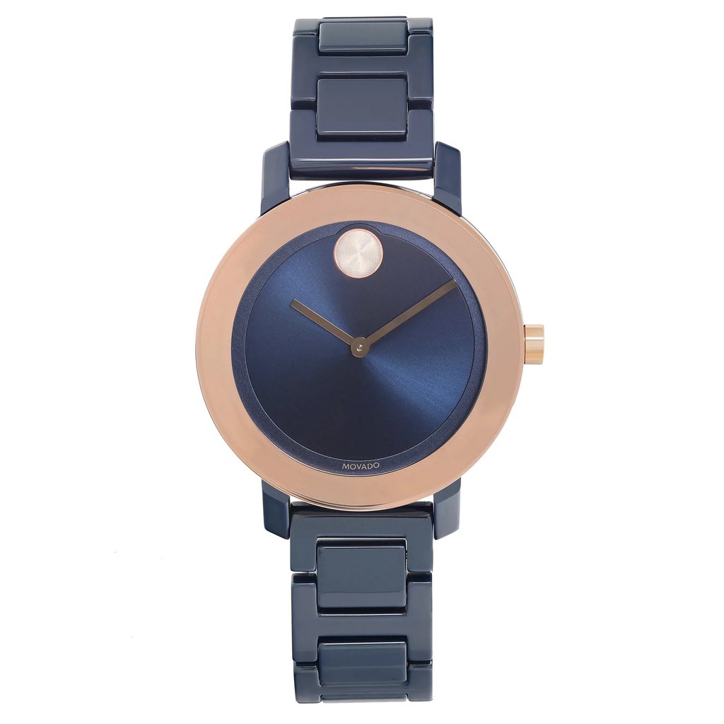 An image of a wristwatch taken from a front full frontal view. The watch features a round dial with a deep blue face and minimalistic design. It has a rose gold bezel and matching hands. The watch band is made of dark, glossy metal links. The image is captured at a close distance, showcasing the watch's sleek and modern appearance.