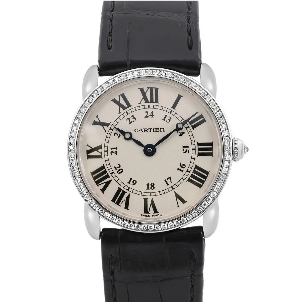 An image of a pre-owned wristwatch taken from a front close-up angle. The watch features a round face with black Roman numerals and a silver bezel adorned with small crystals. The timepiece has a black leather strap with visible stitching. The brand name is visible on the watch face.