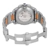 An image of a pre-owned Cartier men's wristwatch, viewed from the back at a slight angle, showcasing the transparent case back and the intricate movement inside. The watch has a stainless steel band with rose gold accents, and the clasp is open. The watch features include a chronograph, date indicator, and luminous hands. The image is taken from a close distance, highlighting the detailed craftsmanship.