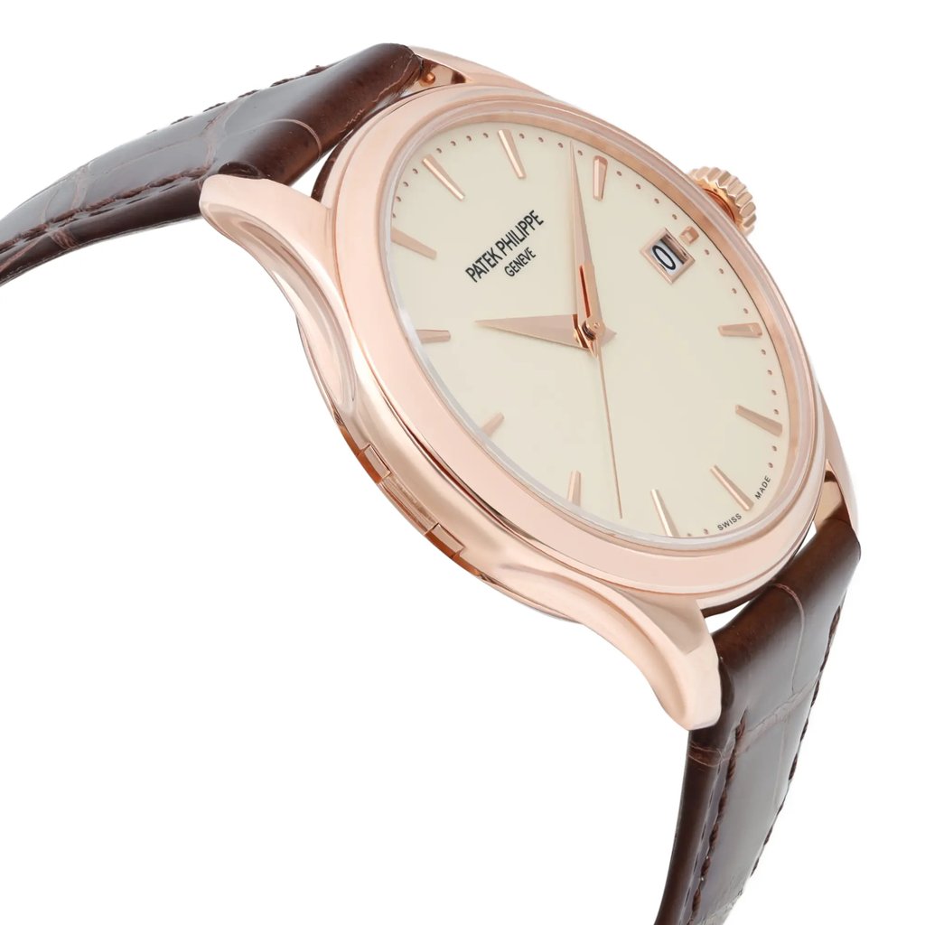 An image of a pre-owned wristwatch shown from a side profile view, opposite the crown. The watch features a rose gold case and a beige dial with minimalist hour markers. The brown leather strap is partially visible, and the watch is angled slightly upward, captured from a close distance.