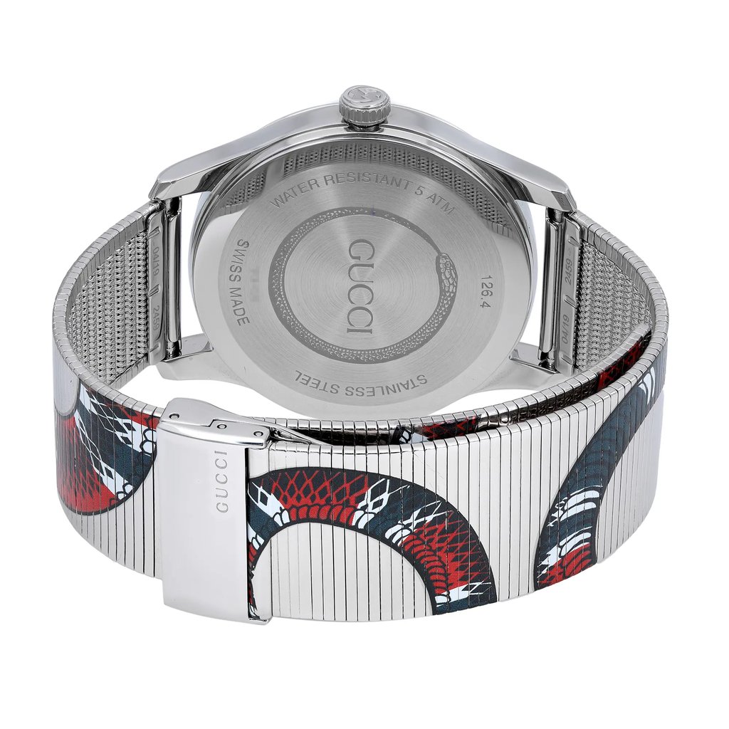 An image of a Wristwatch by Gucci. This Pre Owned item is designed for Unisex Adult, featuring a Casual style. It has a Quartz movement and an Analog display with a Silver dial color. The indices include 12-Hour Dial,Square Indexes. The band is made of Stainless Steel and the case is made of Stainless Steel. The watch has a Round shape with a case size of 38 mm and a case thickness of 8 mm.