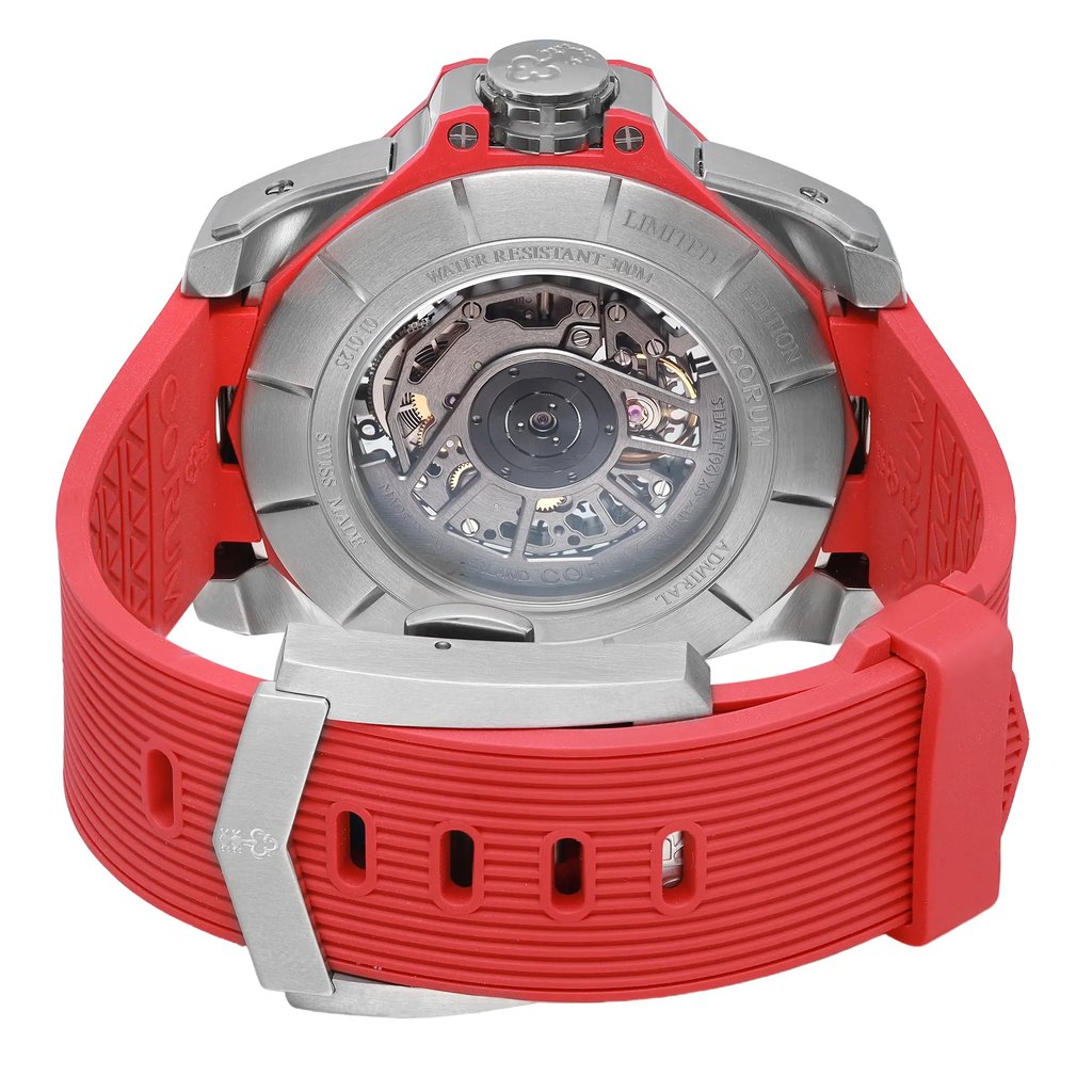 An image of a wristwatch taken from the back view, focusing on the intricate, exposed movement inside the case. The watch features a red strap with a silver clasp. The photograph is a close-up shot, highlighting the details of the mechanical components and the engraved text on the metal case. The condition of the watch is noted as a display model.