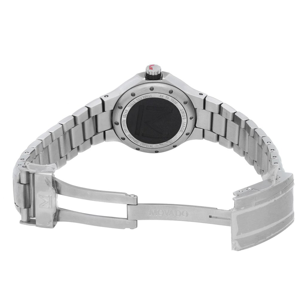 An image of a pre-owned wristwatch taken from the back view, showcasing its open clasp. The watch features a stainless steel band and the brand name "Movado" is visible on the clasp. The photo is taken from a slight angle, providing a clear view of the watch's back casing and bracelet links, at a moderate distance to capture the entire open band.