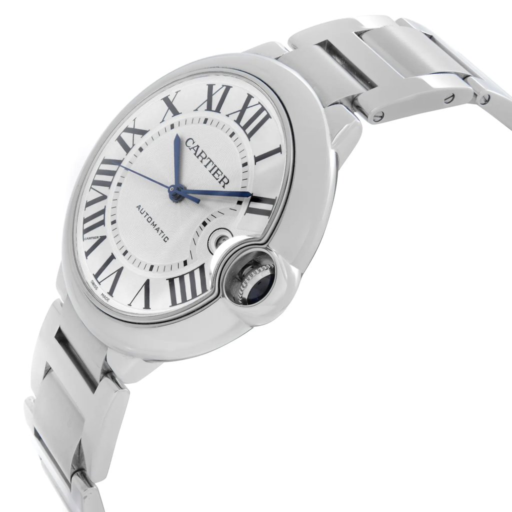An image of a pre-owned wristwatch captured from a side profile view, highlighting the crown on the right side. The watch face features Roman numerals and blue hands, with a metallic bracelet. The angle showcases the watch at a slight tilt, emphasizing its sleek design and polished finish.
