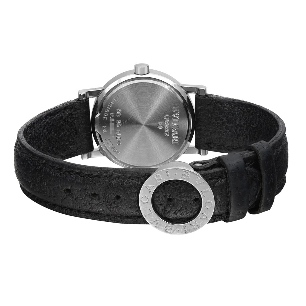 An image of a pre-owned Bvlgari women's wristwatch, showcasing the back of the round silver case. The watch is positioned upright with the black leather strap partially fastened, revealing the Bvlgari logo engraved on a stainless steel ring near the clasp. The angle is slightly above and at a moderate distance, focusing on the watch's backside details and texture of the leather strap.
