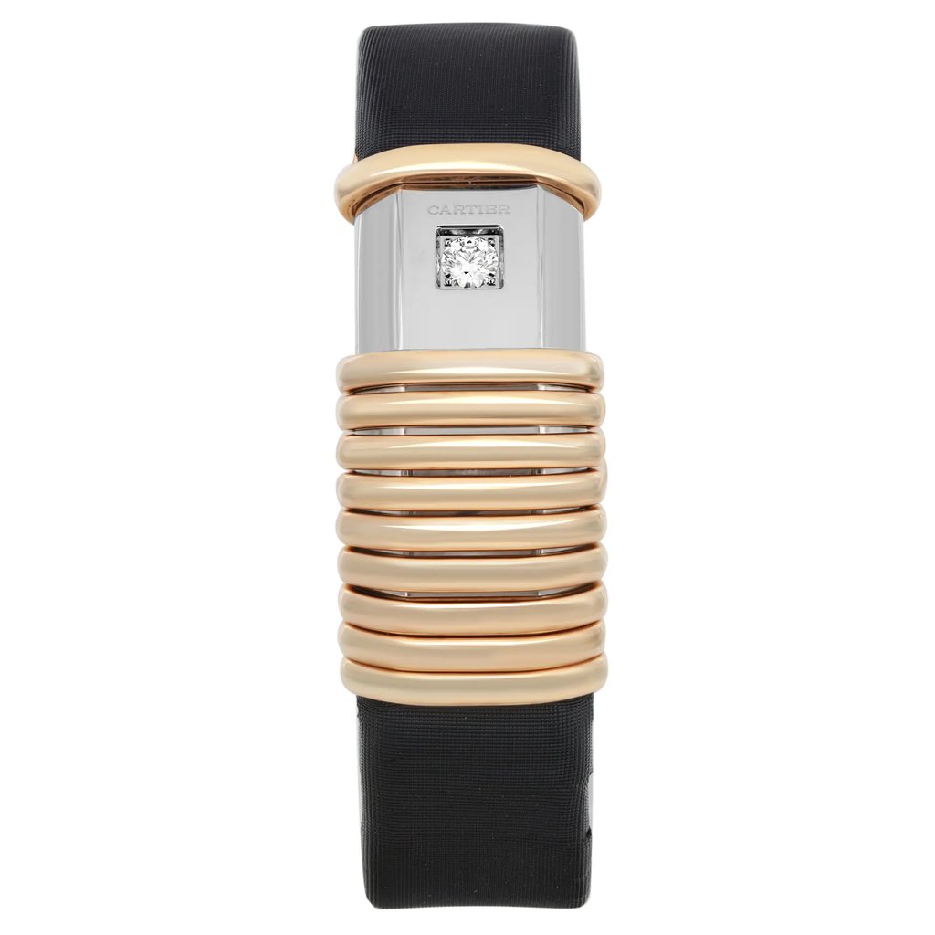 An image of a pre-owned wristwatch shown from a front full frontal view. The watch features a unique design with a series of gold-toned, ribbed rings encircling the central case. The face of the watch is minimalistic with a small square diamond and the brand name visible. The watch is positioned vertically, emphasizing its elegant and streamlined appearance, with a black strap extending above and below the central case.