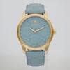 An image of a Wristwatch by Gucci. This Unworn item is designed for Women, featuring a Dress/Formal style. It has a Quartz movement and an Analog display with a Blue dial color. The indices include 12-Hour Dial,No Hour Marks. The band is made of Gold Plated,Stainless Steel and the case is made of Gold Plated,Stainless Steel. The watch has a Round shape with a case size of 38 mm and a case thickness of 9 mm.
