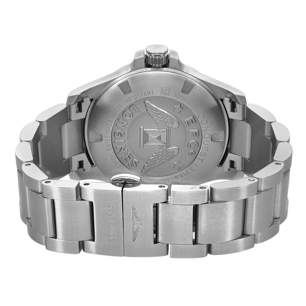 An image of a pre-owned Longines women's wristwatch in like-new condition, showing the back view with a close-up of the screwback case and fold-over clasp. The stainless steel caseback is engraved with the brand's emblem and text, and the stainless steel band is visible with a matte finish. The watch is positioned centrally against a white background, with the back of the watch facing the viewer and the clasp partially open to the right, at a close distance to allow clear visibility of the details.