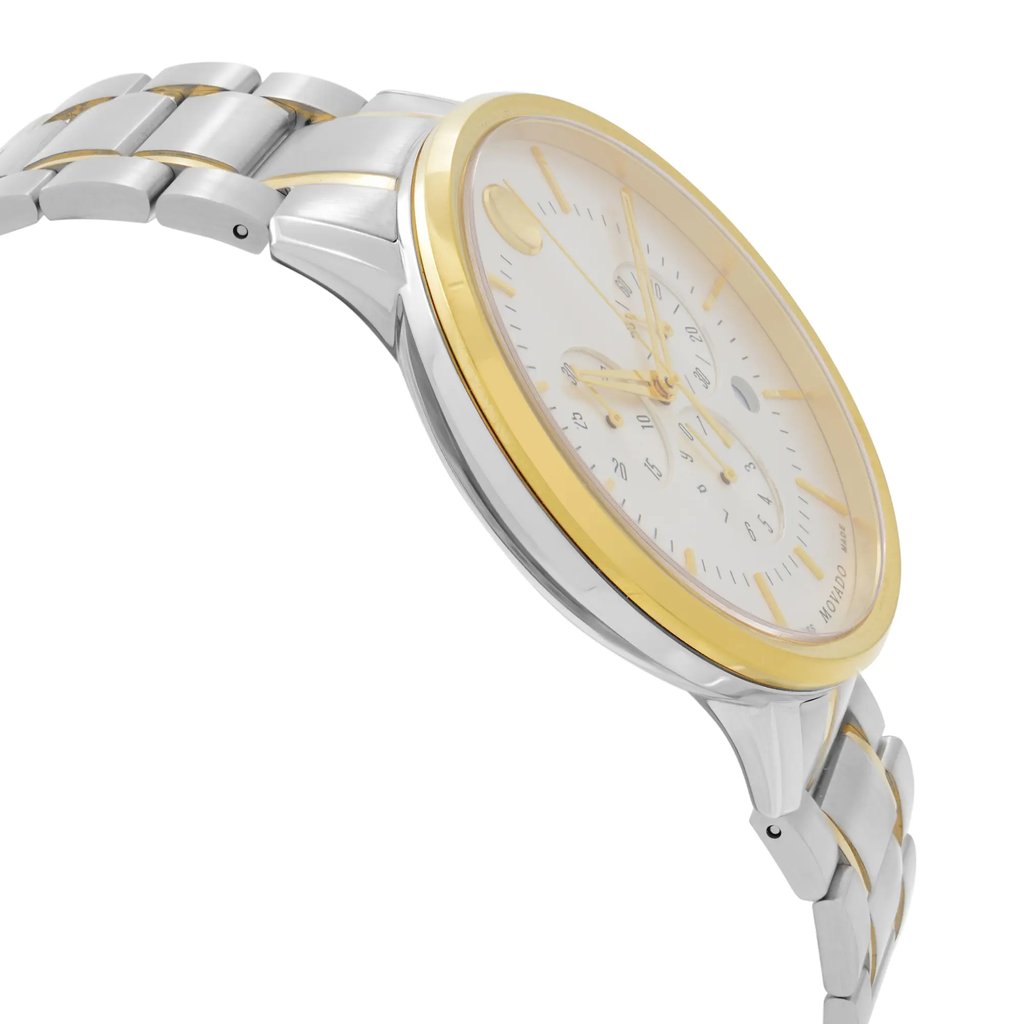 An image of a wristwatch shown from a side profile view, opposite the crown. The watch has a metallic silver and gold-toned bracelet band. The dial is visible at an angle, showcasing a white face with gold details. The image is taken from a close distance, emphasizing the new condition with noted defects.