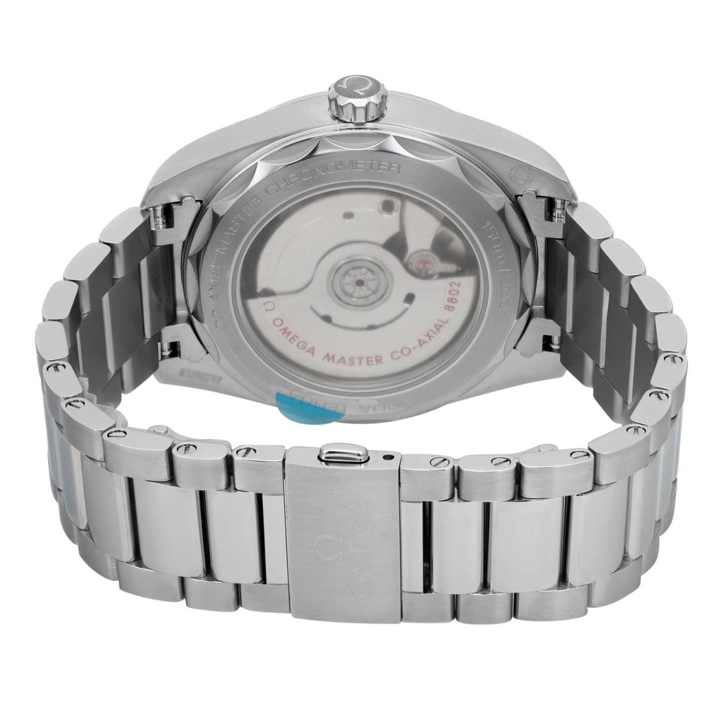 An image of a wristwatch showing the back view, highlighting the closed clasp. The watch is unworn, with a metallic band and visible movement through a transparent case back. The photograph is taken from a close distance, capturing the details and engravings on the clasp and the back of the watch.