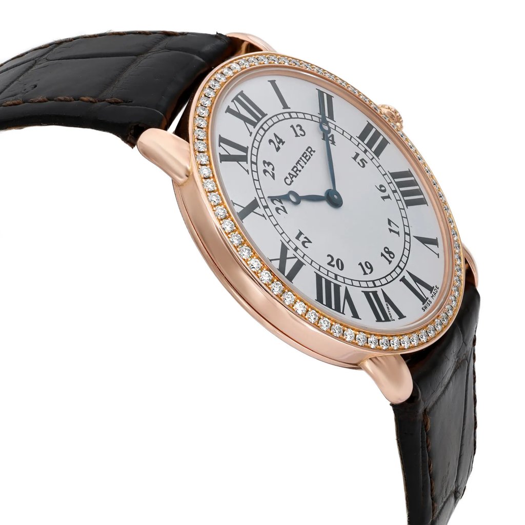 An image of a pre-owned wristwatch taken from a side profile view opposite the crown. The watch features a round face adorned with Roman numerals and is encircled by a diamond-studded bezel. The case is made of a rose gold-colored metal, and the band is a textured black leather strap. The angle and distance highlight the watch’s elegant design and luxurious details.