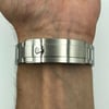 Back View Of Screwback Back Case And Closed Stainless Steel Band Of Rolex 114060 Watch Pre Owned Condition