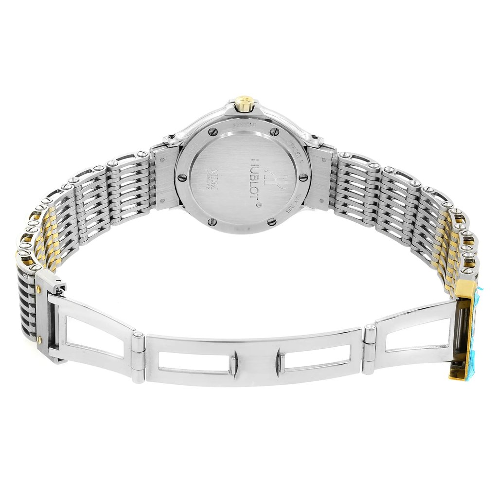 An image of a pre-owned wristwatch viewed from the back, showcasing an open clasp. The watch is positioned at eye level, capturing the entire band and the back of the watch face. The angle is straight on, with a moderate distance allowing a clear view of the metal links and clasp details. The watch features a metallic finish with a mix of silver and gold tones.